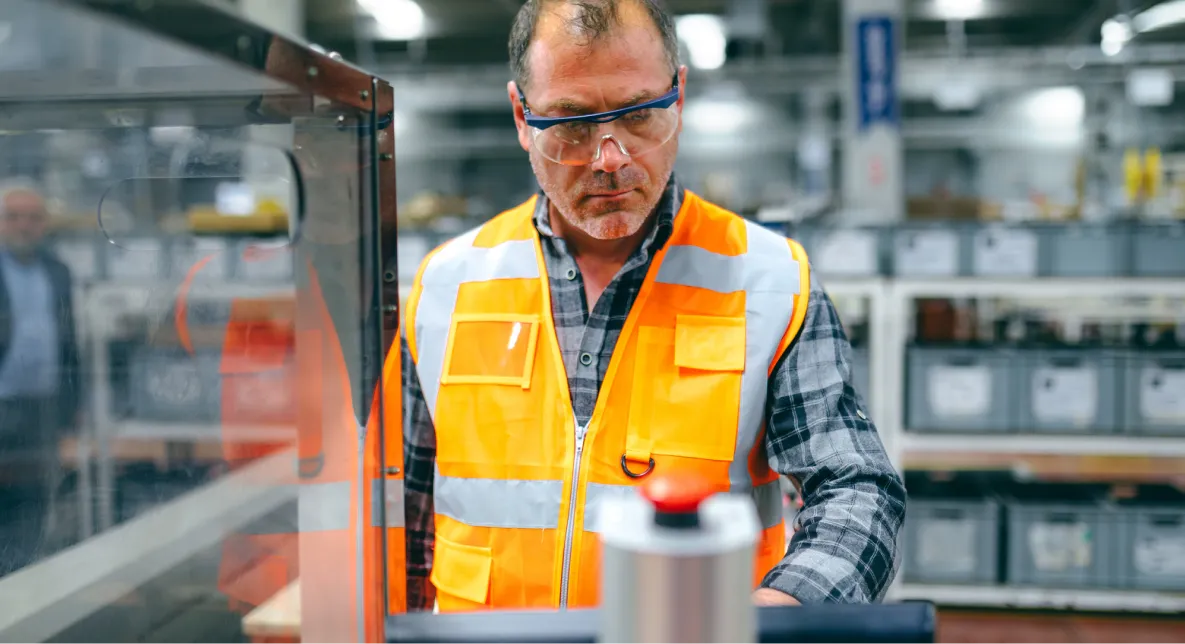 Factory technician operating equipment at a Harbour Group manufacturing facility.