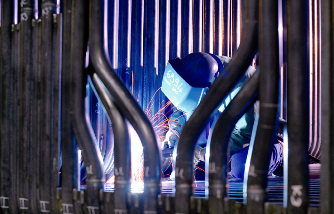 Skilled welder performing fabrication work for a Harbour Group portfolio company.